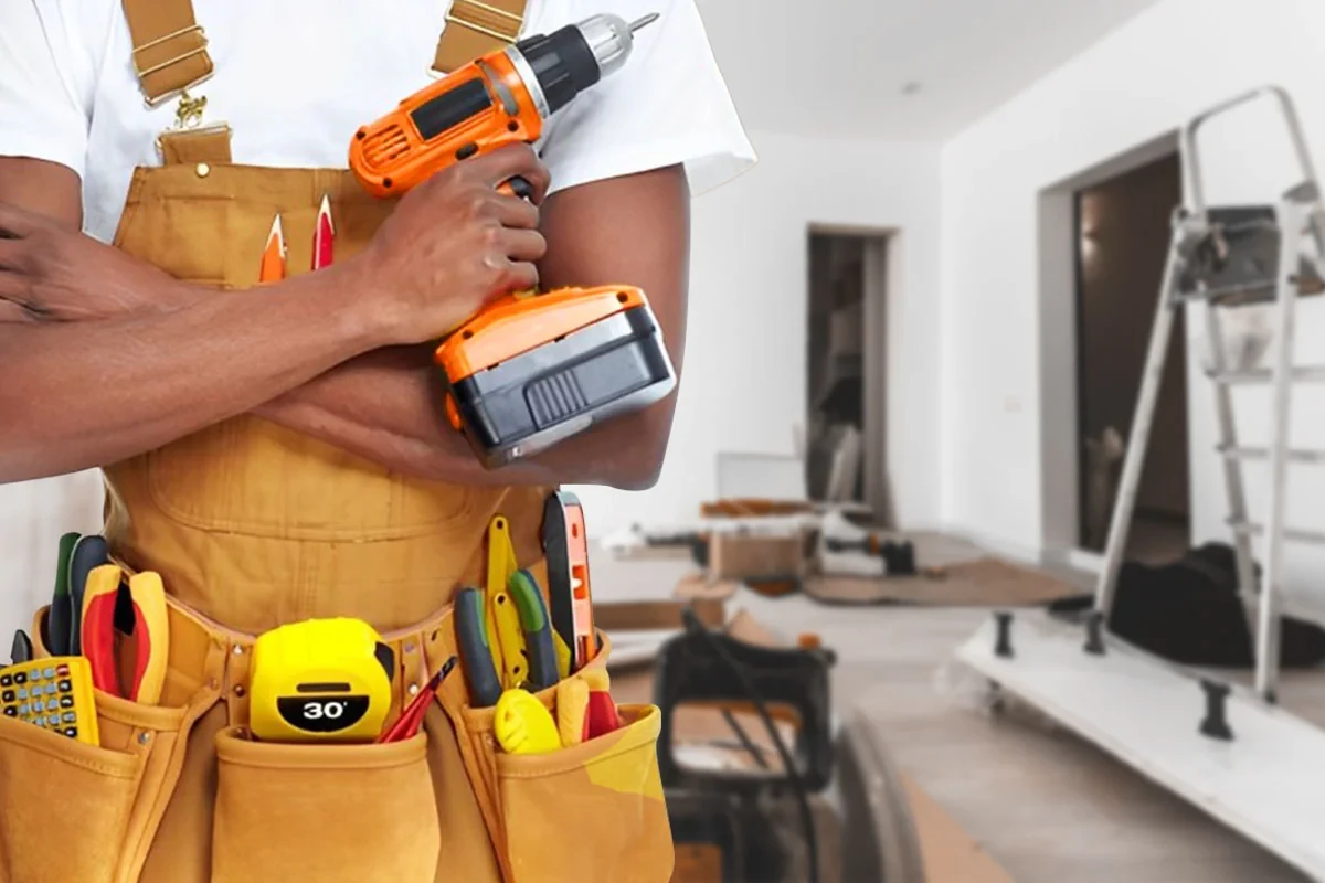 Handyman with a cordless drill and tool belt in a room under renovation, handyman and home maintenance services in Dubai by Limech