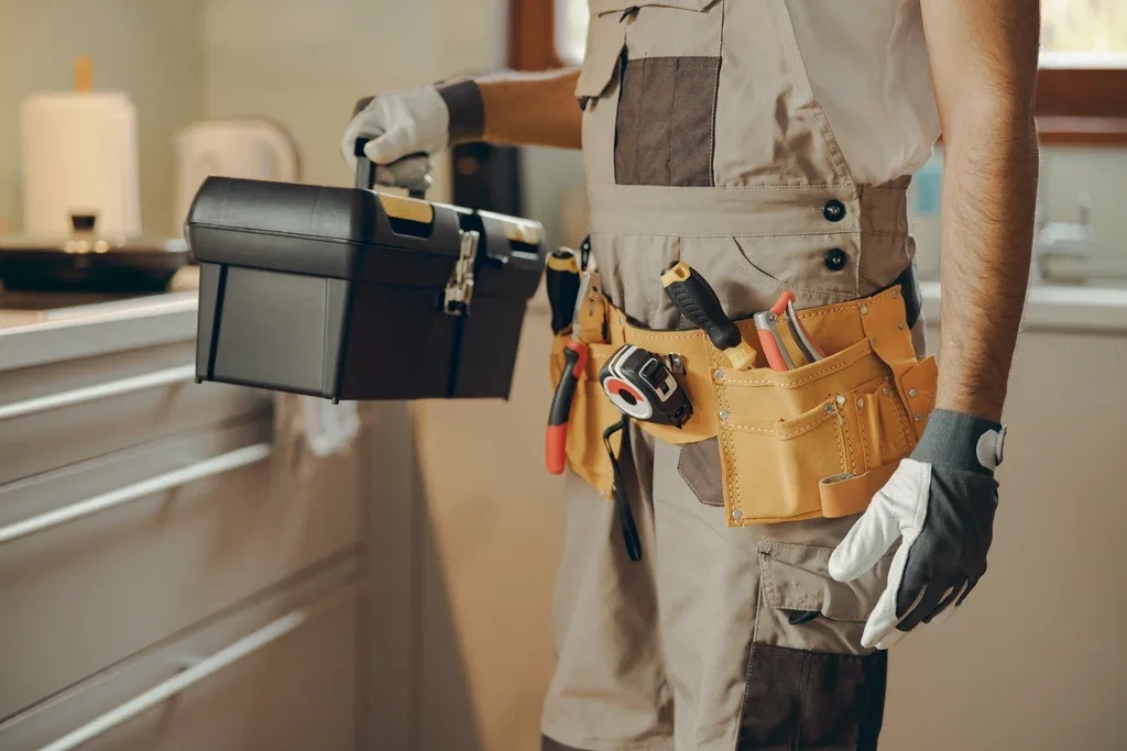 Handyman with a tool belt and toolbox ready for home repair and maintenance services in Dubai by Limech